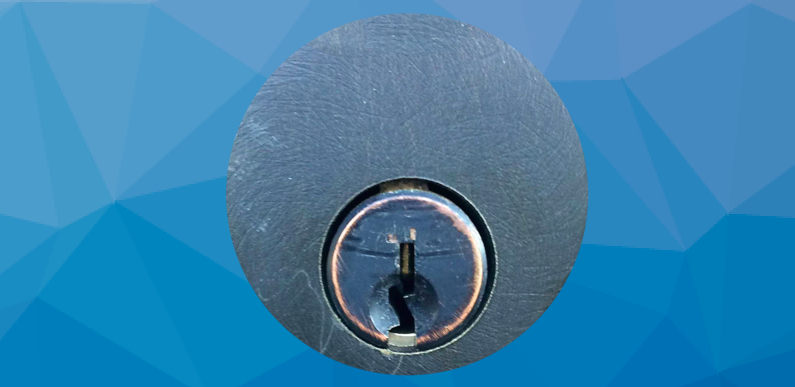 Lock keyway set against a blue geometric background.