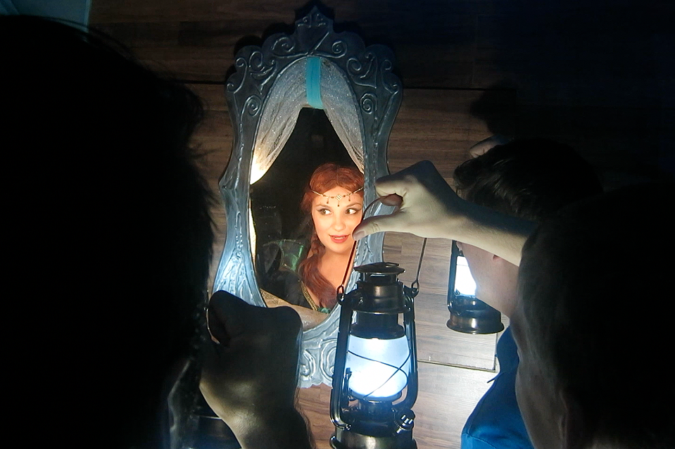 A princess looking at her reflection in a mirror.