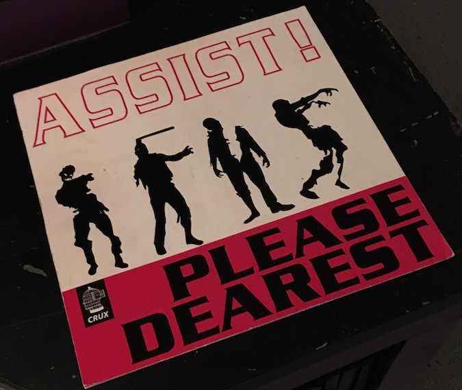 In-game: Album art shows 4 zombies and read's "Assist! Please Dearest"