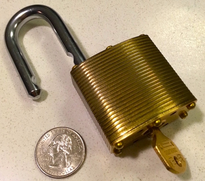 The Commando Lock Marine Brass unlocked. The shackle has the curved cutouts that indicate that it locks with ball bearings.