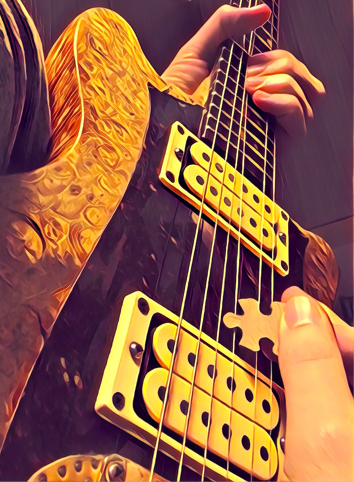 Stylized close up of someone playing a guitar solo with a jigsaw puzzle piece as a pick.