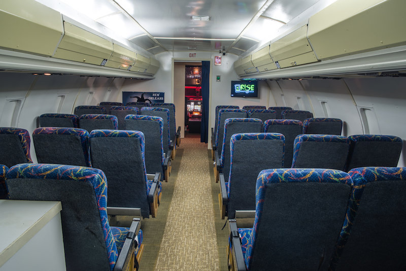 In-game: The gamespace looks exactly like the interior cabin of a commercial airliner.