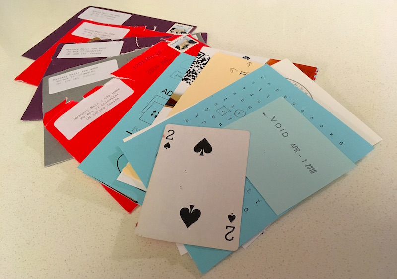 Photo of 5 opened letters and a pile of assorted puzzle material including a partial QR code, a 2 of spades, and a cipher grid.