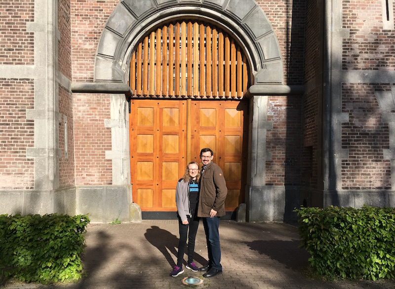 Lisa and David standing in front of the castle-like gates of the Breda Prison Dome