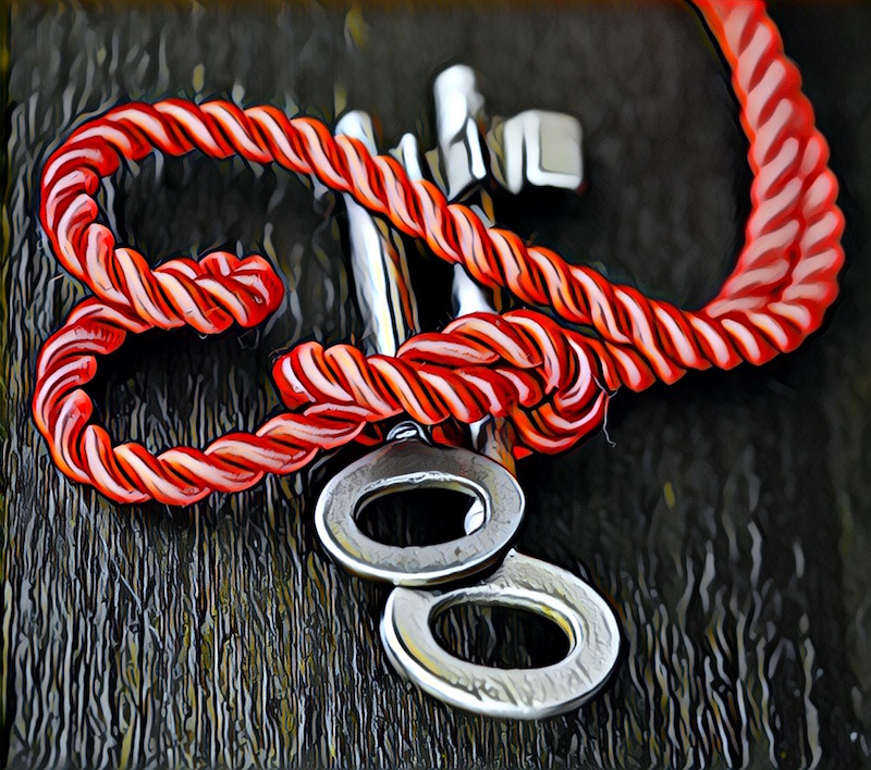 A heart made of red rope tying two old lever lock keys together.