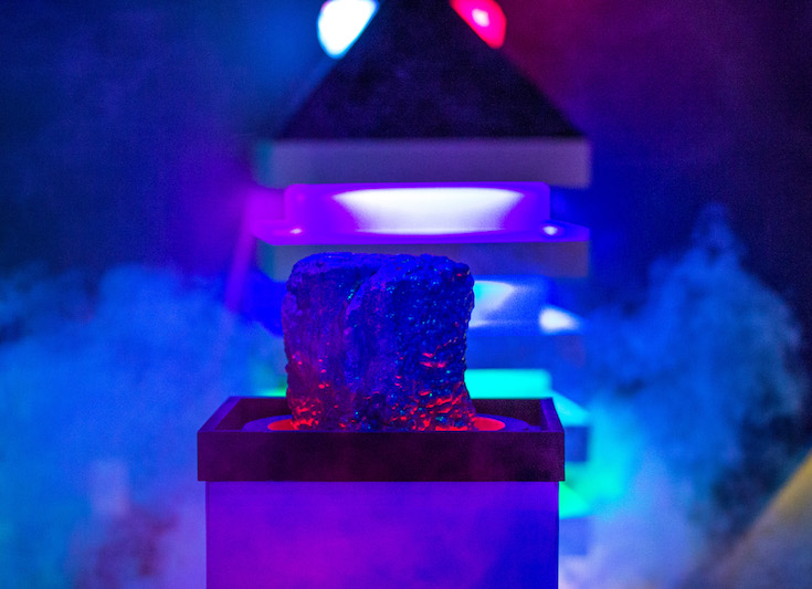 In-game: A mysterious location filled with fog. A rock sits on a pedestal. 