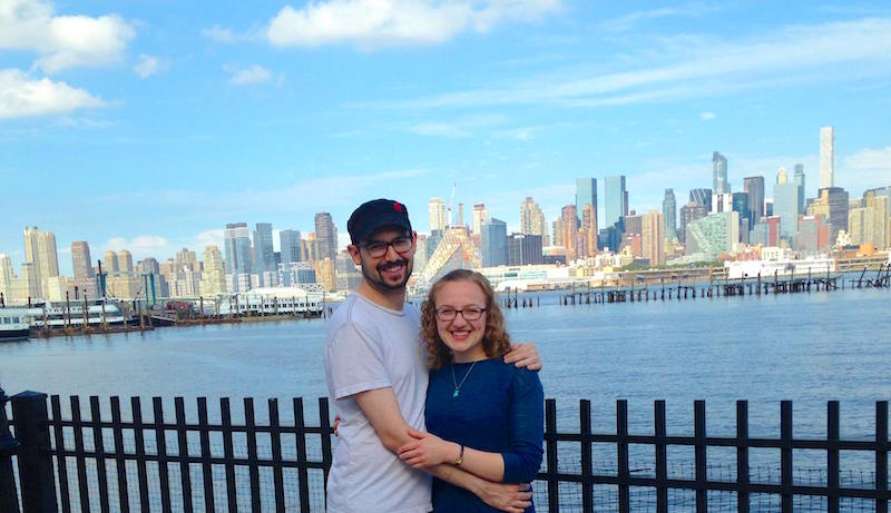 Lisa and David along the Hudson River, New York City in the background.