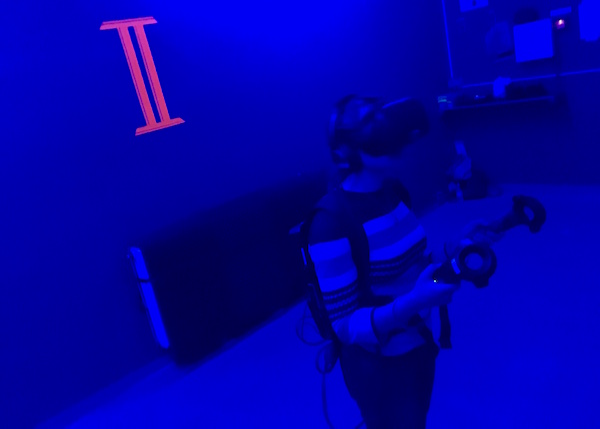 In-game: Lisa in her dedicated space wearing the VR rig.