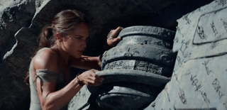 Lara Croft twisting a large stone pillar into place.