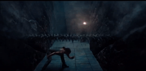 Lara Croft leaping over a fast moving bar of spikes then sliding under another as it grazes her cheek.