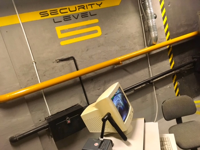 In-game: The concrete military bunker set of Armageddon. The wall reads, "Security Level 5 in yellow."