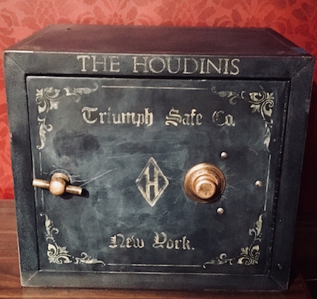 A large old safe that reads, "The Houdinis. Triumph Safe Co. New York."