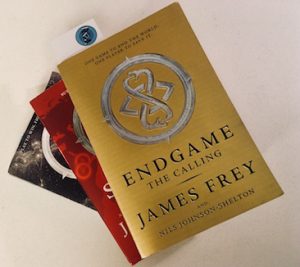 The three installments of the End Game series. The gold covered first volume is on top of the pile.