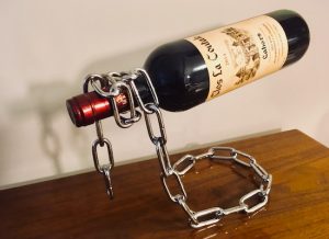 A chain standing upright, magically floating a bottle of wine.