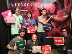 Post-game photo features our team holding up the signs of the character classes that each person played.