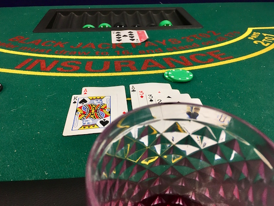 In-game: A card table with blackjack in progress. 