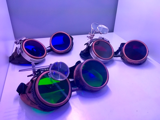 In-game: Three steampunk goggles with different colored lenses. 