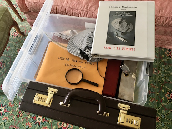 The plastic crate open revealing an assortment of lock boxes, an envelope labeled "confidential" and a binder that says, "Read First."