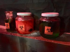 In-game: 3 jars filled with mysterious fluids, all labeled with biohazard stickers.