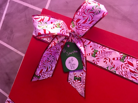 In-game: a wrapped christmas present labeled "To Santa"