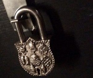 In-game: a large, ornate, silver lever lock.