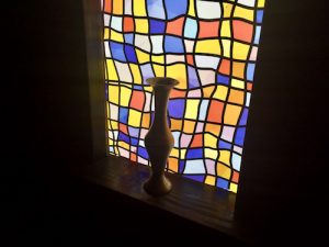 In-game: A vase sitting in a glowing stained glass window.
