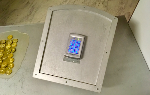 In-game: A digital keypad against a silver table.