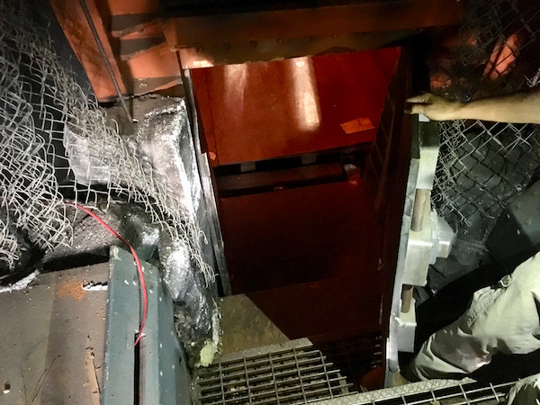 The stairway down into the bunker. It's made of assorted metal components.