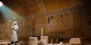 Indiana Jones holding the staff in the Egyptian map room and illuminating the location of the Arc of the Covenant.