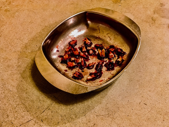 In-game: a stainless steel pan with many bloody teeth.