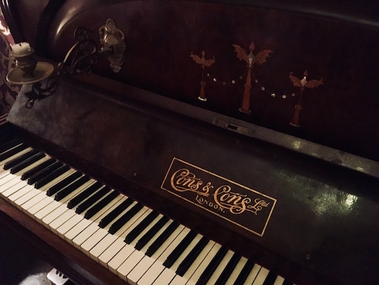 In-game: A closeup of an old wooden piano.