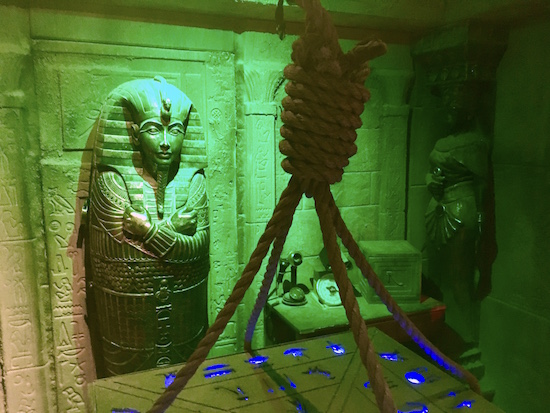 In-game: A sarcophagus leaning against the wall of an Egyptian tomb.