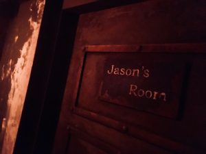 In-game: A close up of a heavy metal door labeled "Jason's Room."