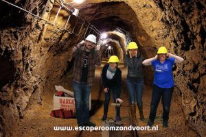 Post game green screen photo of the team in a mine about to detonate dynamite.