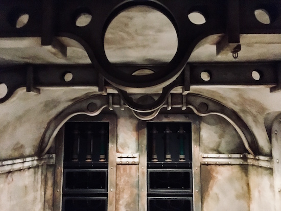 In-game: Interior shot of the Nautilus with weathered and riveted metal walls.