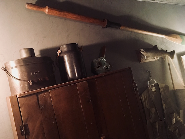 In-game: A cabinet ore, and taxidermied fish hanging on the wall of a fishing cabin.
