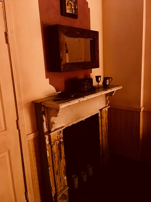 In-game: The aged and worn fireplace in the parlor.
