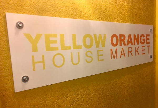 In-game: Sign for "Yellow House Orange Market."