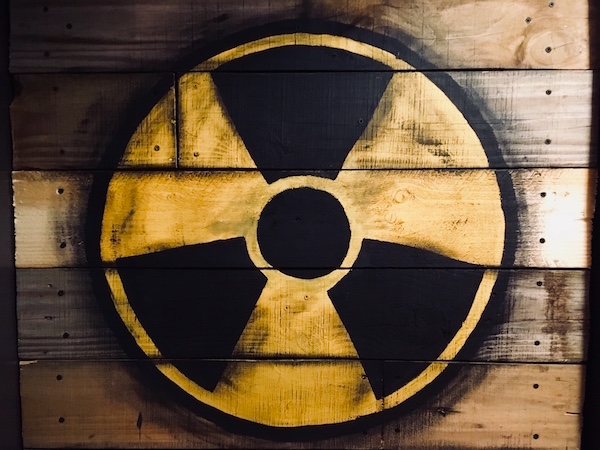 In-game: A wooden door with a nuclear symbol painted on.