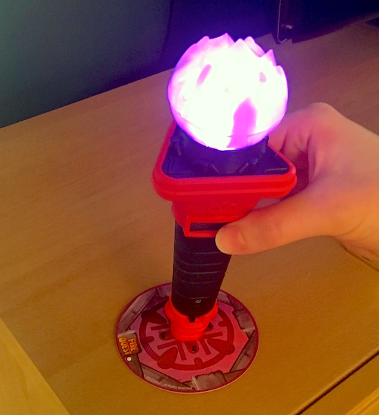 In-game: Lisa placing the purple torch onto the purple pad.