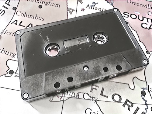 Black & white image of a cassette tape on a map of the US.