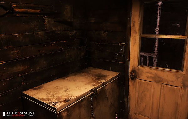 In-game: a large top-loading freezer in a decrepid mud room.