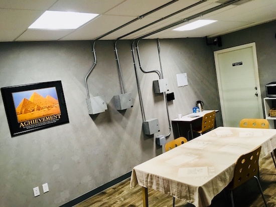 In-game: a wide shot of the the break room.