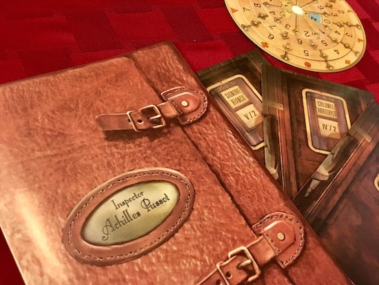 The notebook of Achilles Pussot, an answer wheel, and three train compartment components.