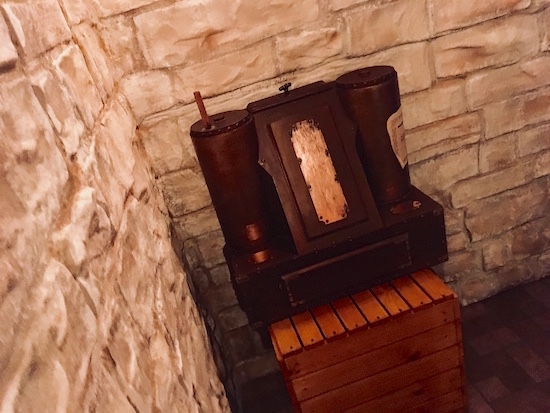 In-game: a strange device in a stone walled room.