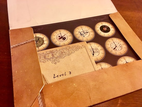 In-game: A folder with a piece of paper with a matrix of clock faces, and an envelope labeled, "Level 3."