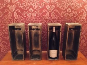 In-game: Four wine boxes, one contains a bottle.