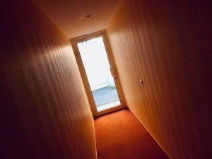 In-game: The hallway of the apartment complex that housed the game.