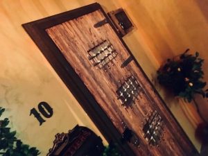 In-game: A hefty wooden door addressed number 10.