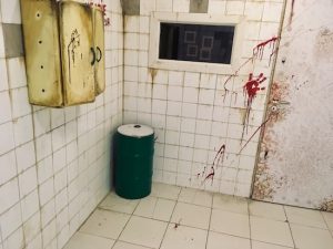 In-game: A dingy, bloodied white-walled asylum.